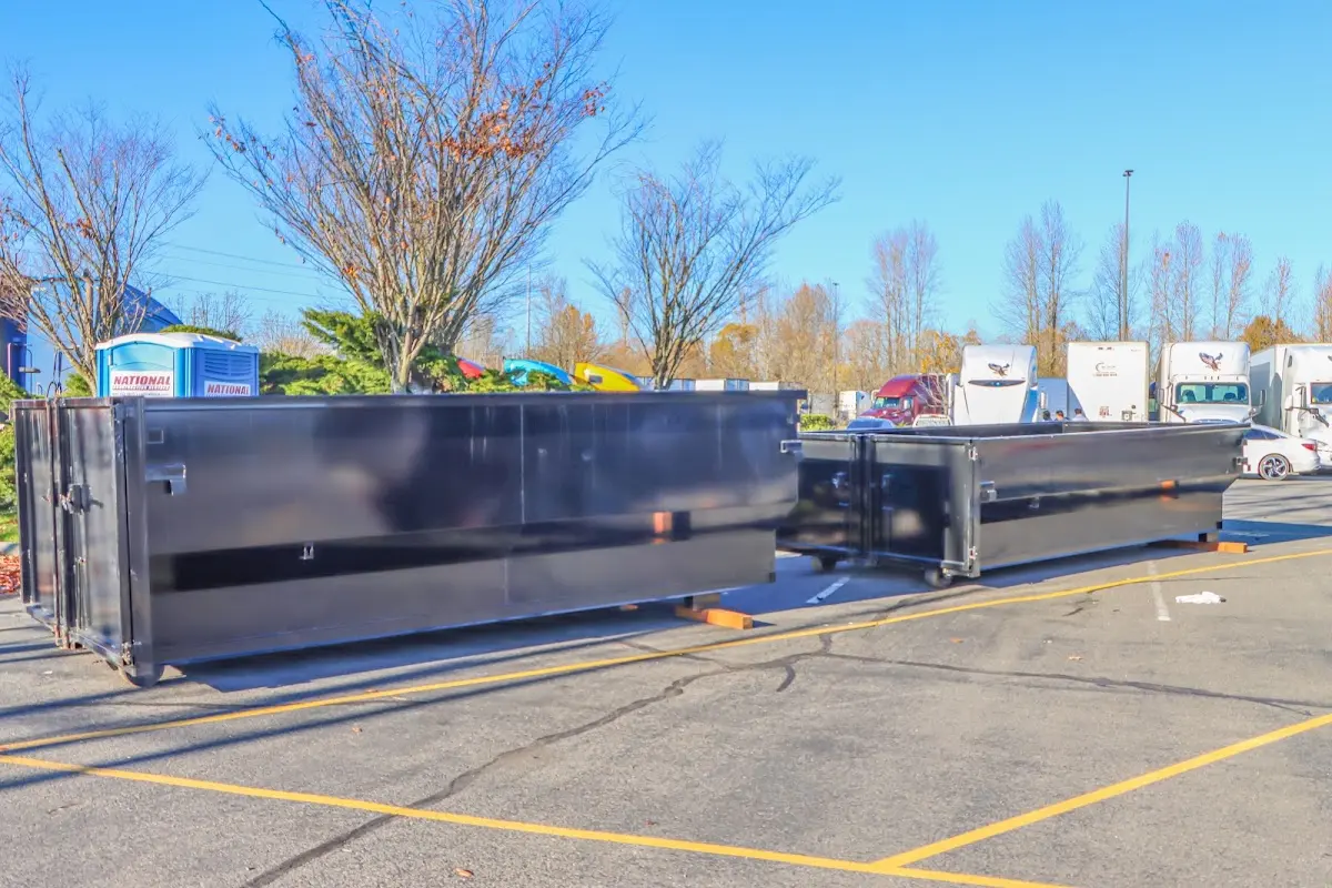 Professional dumpster rental service with roll-off container on residential driveway in Lehighton